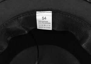 Detail view of the interior hat label showing size 54 and fabric composition details