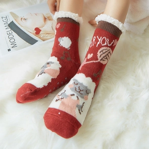 Red and white knit winter slipper socks with sheep pattern and warm faux fur lining