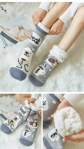 Detail of gray winter slipper socks with plush fleece lining and cute bear coffee pattern