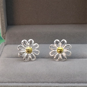 Daisy flower stud earrings with gold center in a gray velvet jewelry box
