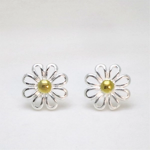 Minimalist daisy stud earrings featuring silver petals and golden center on gray surface
