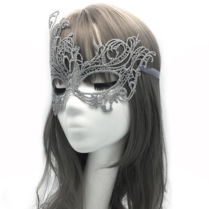 Macro view of silver lace phoenix mask with glitter texture and delicate hollow patterns