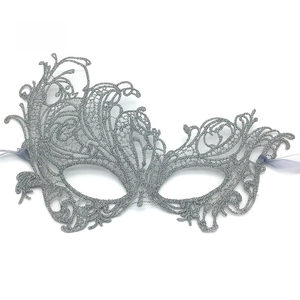 Detailed view of silver phoenix lace mask with glitter finish and ribbon ties