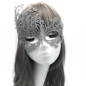 Detailed view of silver hollow lace phoenix mask on a model for masquerade parties