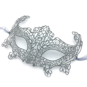 Close-up of silver glitter lace phoenix mask with silk ribbons for masquerade parties