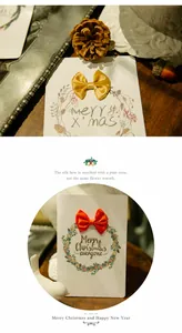 Detailed view of Christmas cards featuring 3D ribbon bows and festive floral wreaths
