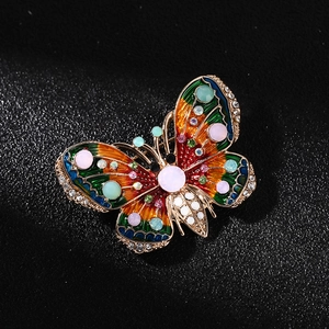 Vintage gold-tone butterfly brooch with colorful enamel wings and sparkling crystals