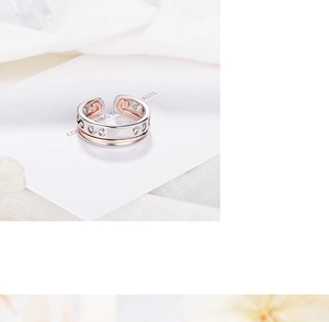 Detailed view of bicolor silver and rose gold adjustable ring with hollow cloud patterns