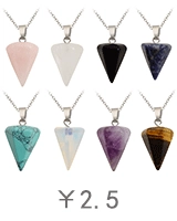 Macro shot of assorted natural crystal stone pendants in polished triangular pyramid shape