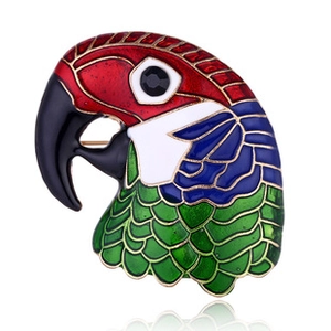 Detail of colorful parrot head enamel brooch with rhinestones and gold-plated edges