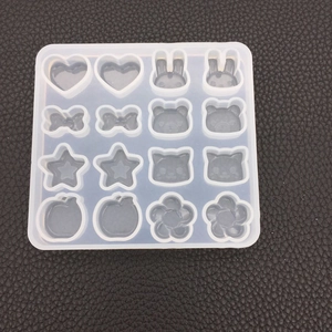 Detailed top view of 16-cavity silicone mold with bunny, heart, and star shapes