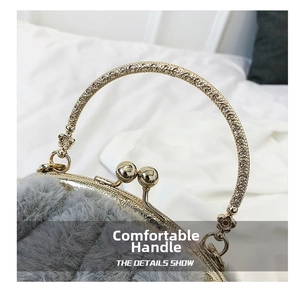 Detail of grey faux fur handbag with ornate golden metal handle and ball clasp closure