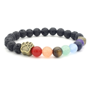 Close-up of paw print charm on a 7 chakra volcanic stone beaded bracelet
