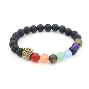 Detail of Seven Chakra paw print bracelet with lava stone and colored gems on white background