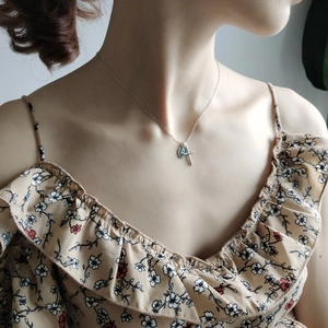 Close-up of a 925 sterling silver necklace featuring cross and Virgin Mary pendants