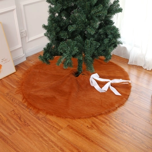 Brown faux fur Christmas tree skirt with white ribbons for festive holiday decorations
