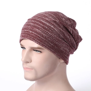 Detail of red and white mixed knit beanie showing textured stripe pattern and slouchy fit