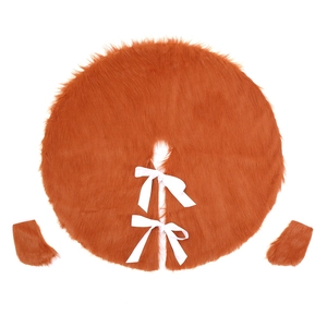 Detail of orange faux fur Christmas tree skirt with plush texture and white silk ribbons