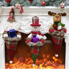 Three festive Christmas character stockings hanging on a white fireplace mantel decoration