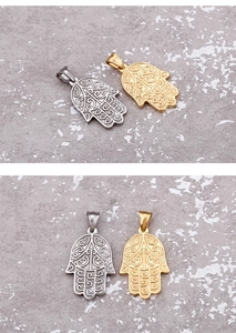 Detail view of gold and silver Hamsa hand pendants with intricate hollow patterns