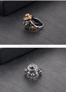 Detail shot of vintage gothic joker rings with smiling faces in gold and silver plating