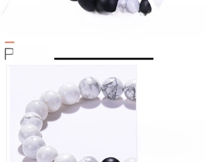 Detail view of 8mm natural white turquoise and matte black lava beads on elastic cord