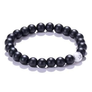 Minimalist 8mm matte black bead bracelet with a single white turquoise marble accent