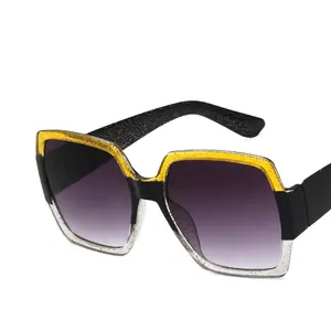 Stylish square frame sunglasses featuring yellow black and gold glitter gradient lenses