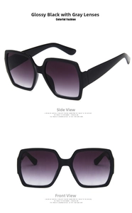 Detail of square oversized sunglasses in glossy black with gradient purple lenses