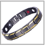 Detail of black and gold magnetic health bracelet featuring therapy stones and clasp