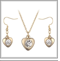 Detailed view of golden heart jewelry set with sparkling crystals and fine chain