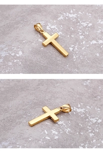 Macro shot of polished gold-plated stainless steel cross pendant on textured stone