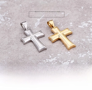 Detailed macro view of gold and silver Egyptian cross pendants with stepped grooves
