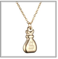 Close-up of golden money bag pendant with dollar sign on a fine chain necklace