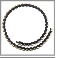 Detail of black and gold twisted rope chain necklace with a secure metal lobster clasp