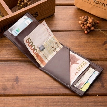 Detail view of brown leather bifold wallet with multiple card slots and cash compartment