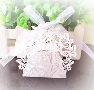 Detailed laser-cut butterfly and heart patterns on a white pearlescent wedding favor box