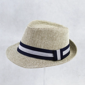 Detailed close-up of woven straw texture and two-tone striped ribbon on a Panama hat