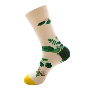 Detail von cremefarbenen Socken mit grünen Blattmustern, Käferprints und gelben Spitzen