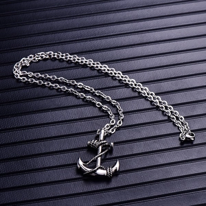 Silver stainless steel anchor pendant necklace with rope detail and O-chain on dark background
