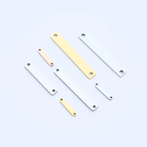 Macro view of polished rectangular stainless steel pendants in gold, silver, and rose gold