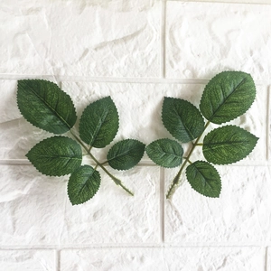 Detail of lifelike silk rose leaves with serrated edges and realistic vein textures