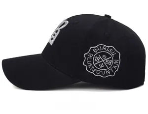 Side view of black cotton baseball cap with white Blue Mountain embroidery detail