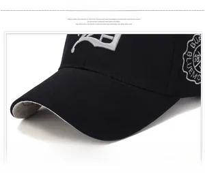 Detailed view of 3D gothic letter D embroidery on black cotton baseball cap fabric