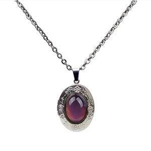 Detailed close-up of vintage oval purple gemstone pendant with floral engraved border