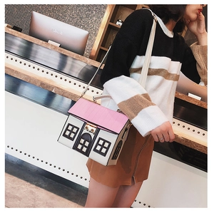Detailed view of creative house-shaped PU leather bag with pink roof and metal lock