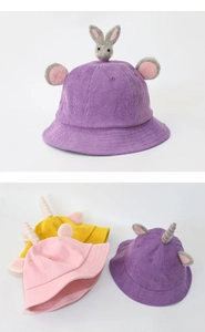 Close-up of children's corduroy bucket hats with cute rabbit ears and unicorn horns
