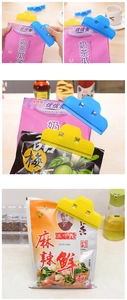 Detailed view of colorful cloud shaped food sealing clips on snack bags in a kitchen
