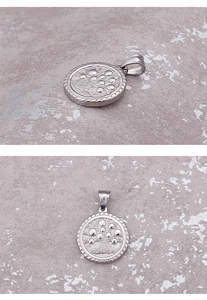 Detailed views of silver stainless steel round tree of life pendant with relief texture