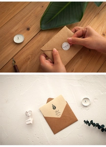 Close-up of vintage kraft paper envelopes with greeting cards and aesthetic stickers